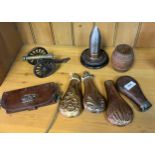 A Collection of military collectables; Small Brass and cast iron firing canon, Four copper and brass