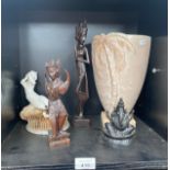 A Shelf of Eastern deities figures, Beswick palm tree vase along with Moore and co style cherub