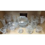 A shelf of glass and crystal vases and bowls