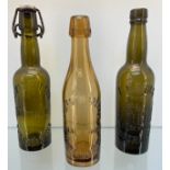 Three antique Dunfermline glass bottles; Amber coloured- James Woodrow- Abbey Works- Dunfermline,