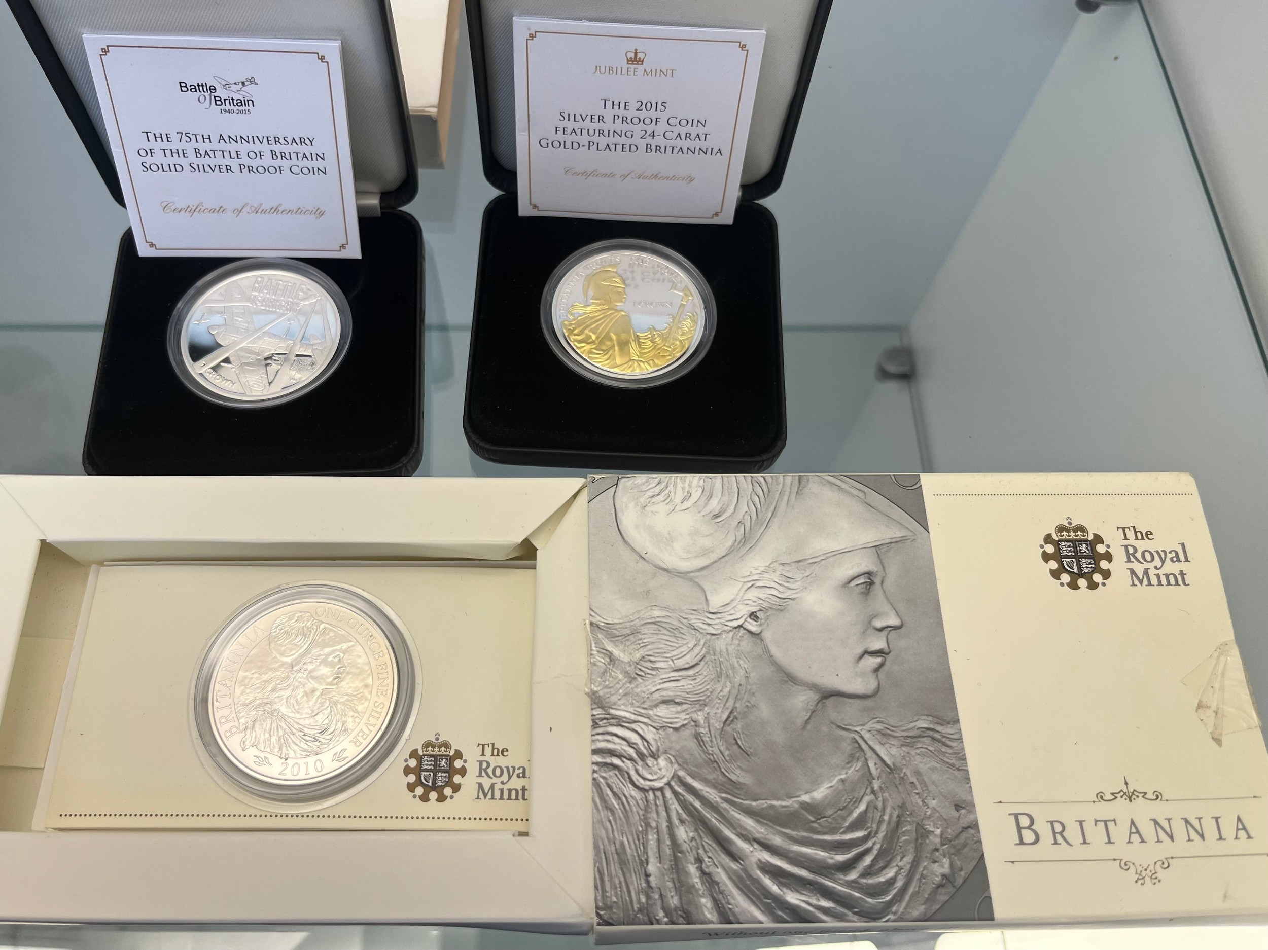 Three silver mint coins; The Royal Mint 'Britannia' 2010 £2 silver bullion coin with box, Two - Image 2 of 2