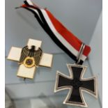 Reproduction German WW2 Knights cross and one other enamel badge.