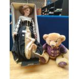 A large boxed hand painted porcelain doll with stand along with Harrods teddy