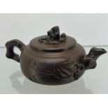 A Chinese Yixing pottery sake/ tea pot. Impressed signature to the base and lid. [8x18x11cm]