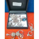 A Collection of silver earrings and silver rings.