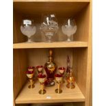 Two shelves of glassware to include Bohemian glass decanter and glasses