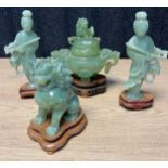 A lot of four Chinese green jade sculptures; A Pair of Geisha figures on wooden stands, Censor