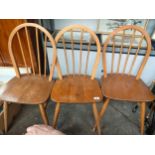 A set of three pine kitchen chairs