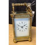 French brass carriage clock- late 19th century- the enamel white dial with black Roman numerals,