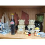 A shelf of collectables includes original Pepsi cola bottle full, Winnie the pooh trinkets pot and