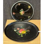 Two antique paper mache black lacquered and hand painted floral design serving trays.