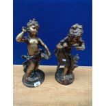 A Pair of Heavy brass/ bronze style cherub figures supported on bases