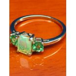 10ct yellow gold ladies ring set with Ethiopian opal stone off set by two green gem stones. [Ring