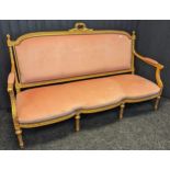 Louis XVI style settee, within a gilt frame and upholstered in a blush pink material