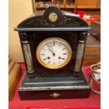 A Victorian Slate mantel clock with enamel face