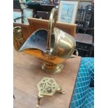 A brass coal skuttle along with stand