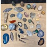A Collection of fossils, agate and geode stones; Ammonites, marble eggs and coral pieces