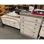 A 1960s marble affect dressing table with mirror and matching five drawer chest of drawers