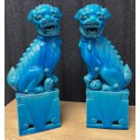 A Large pair of Chinese foo dog ceramic sculptures. Finished in a Turquoise drip glaze. [45cm high]