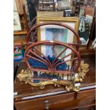 A gilt framed mirror, bamboo magazine rack, three cast iron oval trivets and two framed golfing