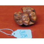 Japanese hand carved root wood netsuke of seven various Oni Masks. [Signed]
