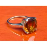 10ct yellow gold ladies ring set with a large round cut Citrine style stone. [Ring size P] [3.