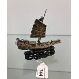 Antique silver Chinese war junk boat sat upon a hand carved wooden stand. [11.5x11x3cm]