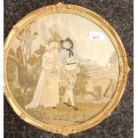 Circular ornate framed needlework depicting a man and women with ships at sea. [33x33cm]