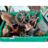 A box of eastern themed items includes bronze style goddess figure, carved wooden figures and many