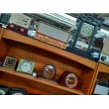 A Shelf of art deco period clocks along with the American ginger bread clock [As Found]