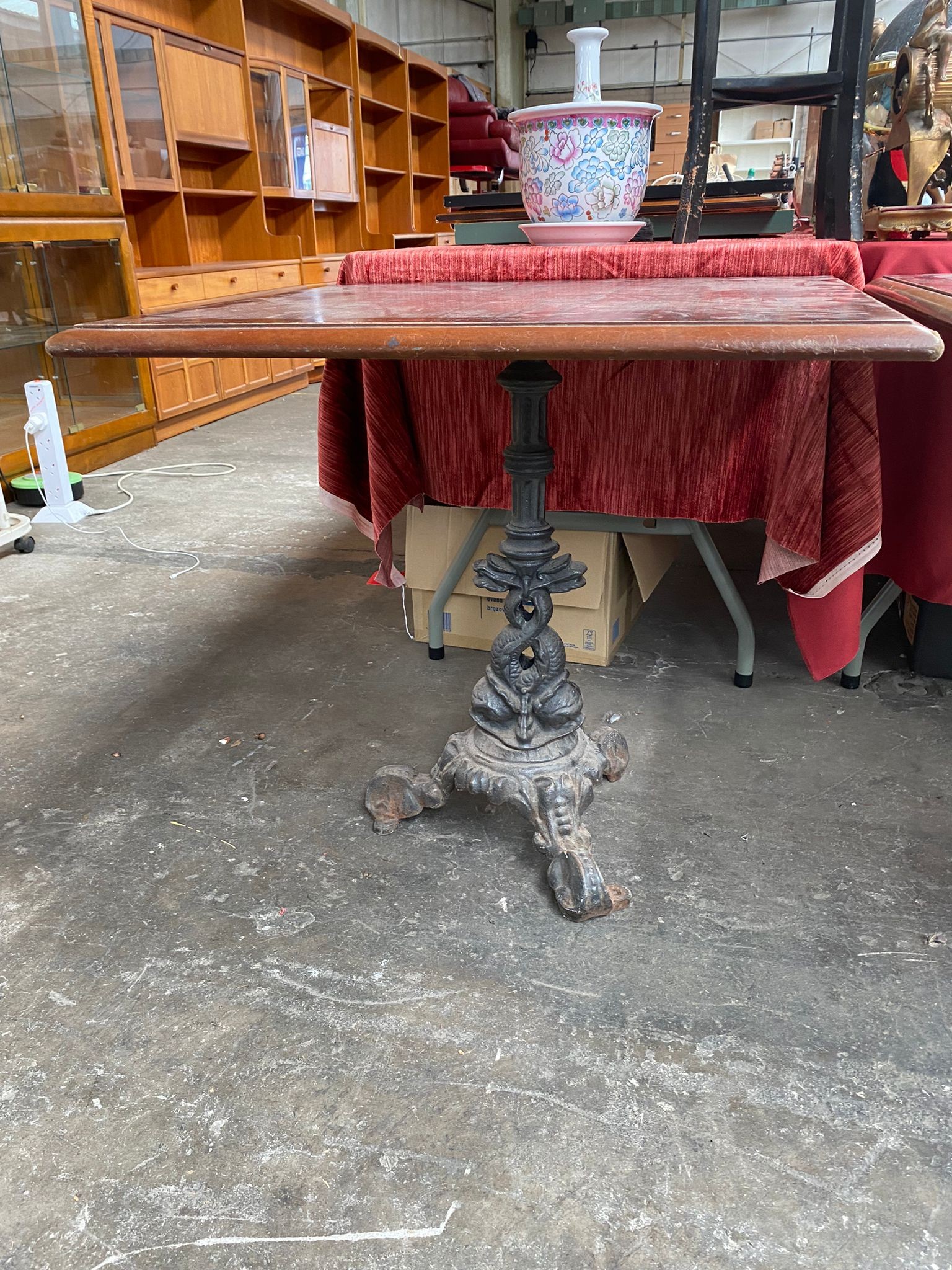 A Cast iron based Bar table with mahogany top