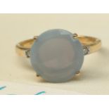 10CT Yellow gold ladies ring set with a large opalescent stone and gem stones to each shoulder. [