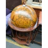 A reproduction globe drink cabinet