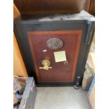 Vintage Smithers & Co safe with key, has brass formed hand handle.