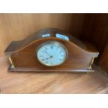 Antique French mantel clock, Mahogany body with brass designed columns and bun feet. Working