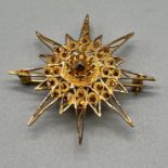 High grade foreign gold star style pendant/ brooch. [Tested positive for 18ct-24ct gold] [7.95grams]