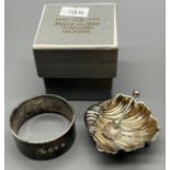 Two silver items; Birmingham silver shell design salt with matching spoon, Britannia silver napkin