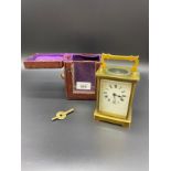 Antique brass carriage clock with travel case and key. In a working condition.