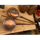 Pair of antique copper bed warmers with turned handles, together with a brass and copper hunting