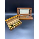 Two Boxed antique instruments; Brass pocket microscope and Syke's Hydrometer within a mahogany box.