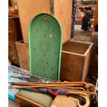 Vintage bagatelle game together with various walking sticks and umbrellas