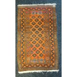 Hand woven Indian ornate rug, Orange ground. [140x79cm]