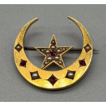 Antique 15ct yellow gold brooch; half crest moon and star, fitted with seed pearls and Ruby