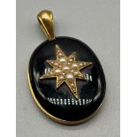 Victorian Gold mourning pendant; set with a large black stone with a centre star fitted with pearls.