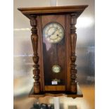Antique wall clock with key and pendulum. in a working condition.