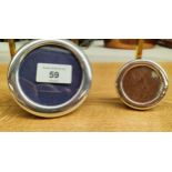Two small silver round photo frames. [largest 9.5cm diameter]