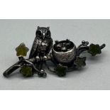 Unmarked silver brooch made up of an Owl, nest of chicks and agate leaves.