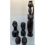 Selection of African hand carved tribal studies; mother carrying water pot on her head and child