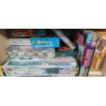 A Shelf of Sealed board games; Lord of the Rings, Robot Wars The Game, Monopoly, Harry Potter Trivia