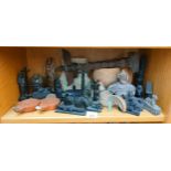 A shelf of collectables to include Egyptian figures and tribal items, Roman oil lamps, Maya